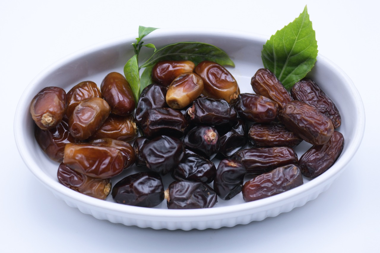 Black dates in a serving bowl