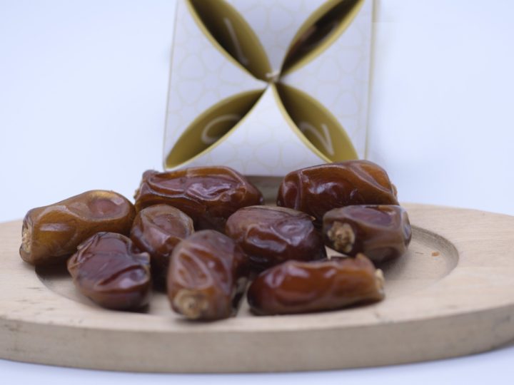 Dates arranged on a wooden serving board