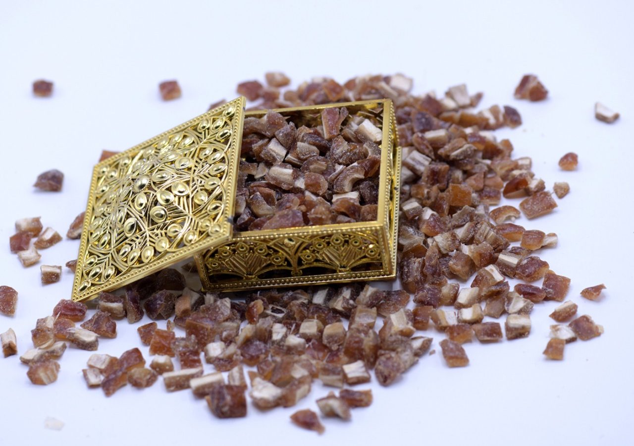 Diced dates spilling from a golden box